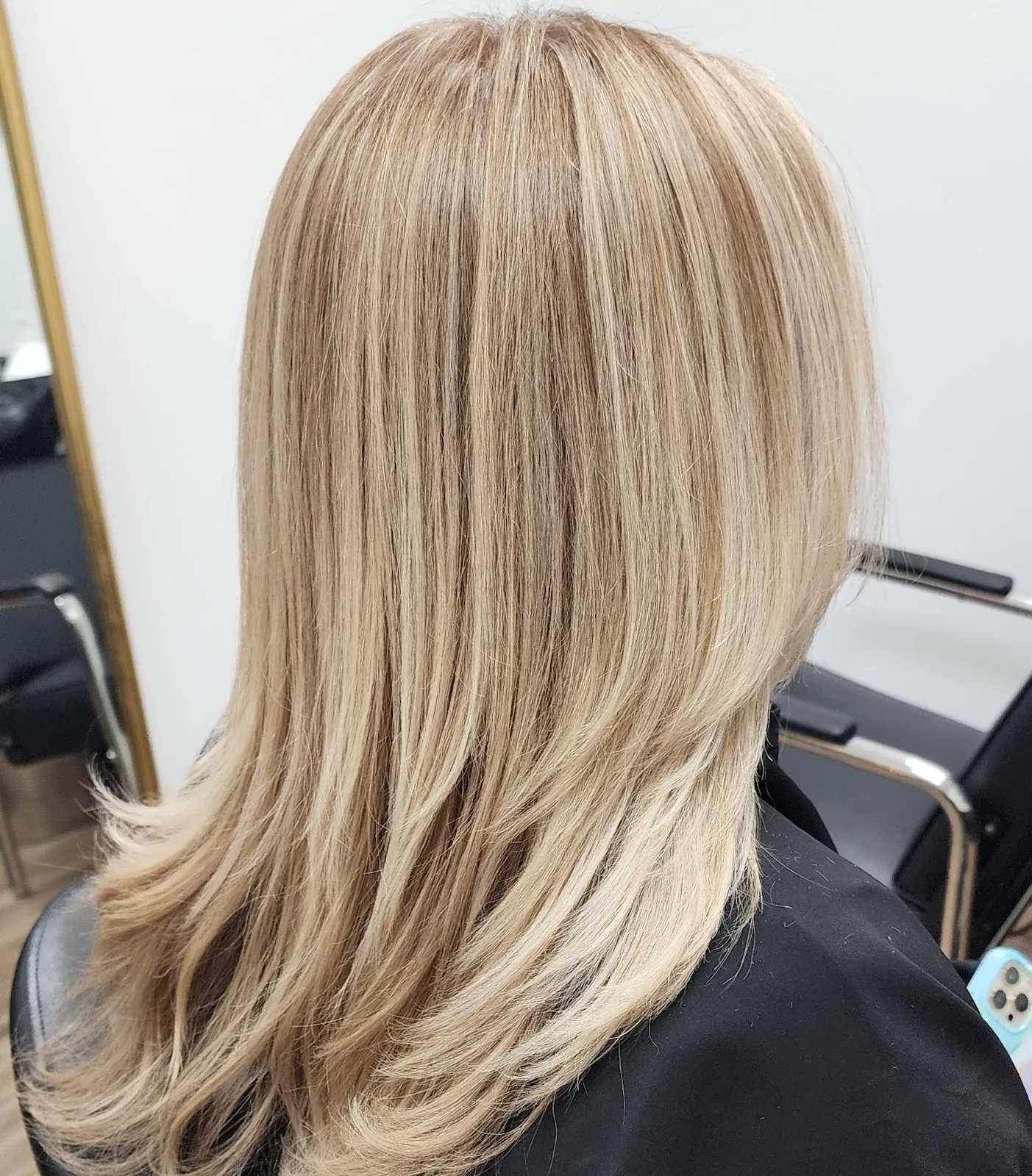 Soft blonde highlights, finished and styled at the color station