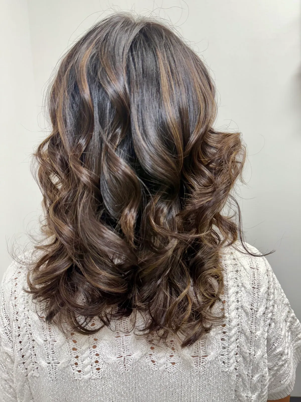 Hand-painted highlights with a bouncy curled blowout